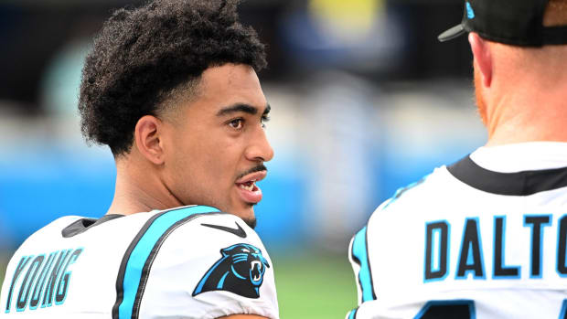 Panthers quarterback Bryce Young speaks with Andy Dalton during a practice.